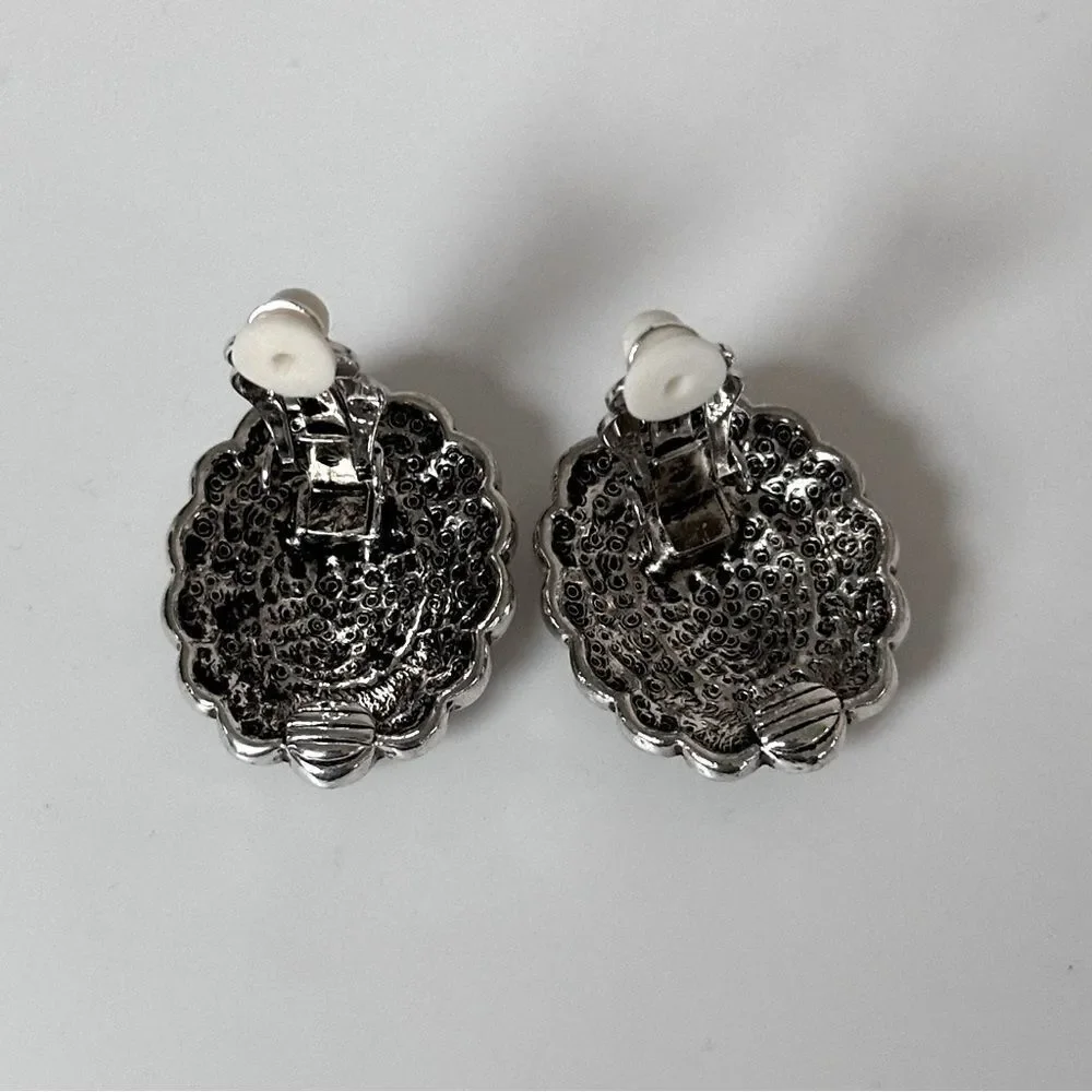 Vintage Sterling Silver Oval Clip-On Earrings with a black stone.
